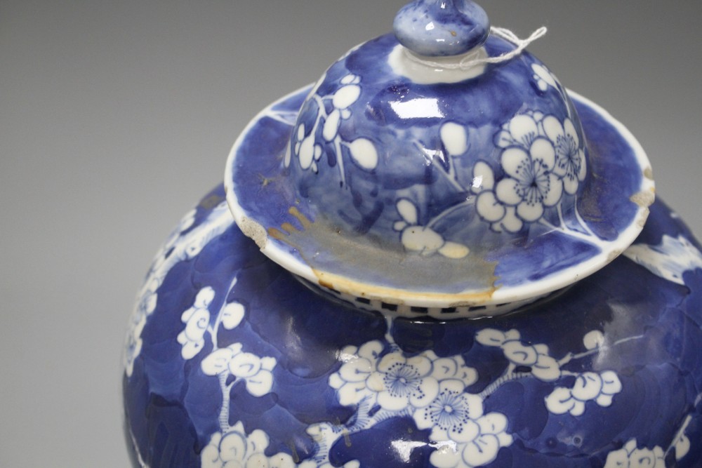 A pair of late 19th century Chinese prunus pattern baluster vases and covers, height 29cm